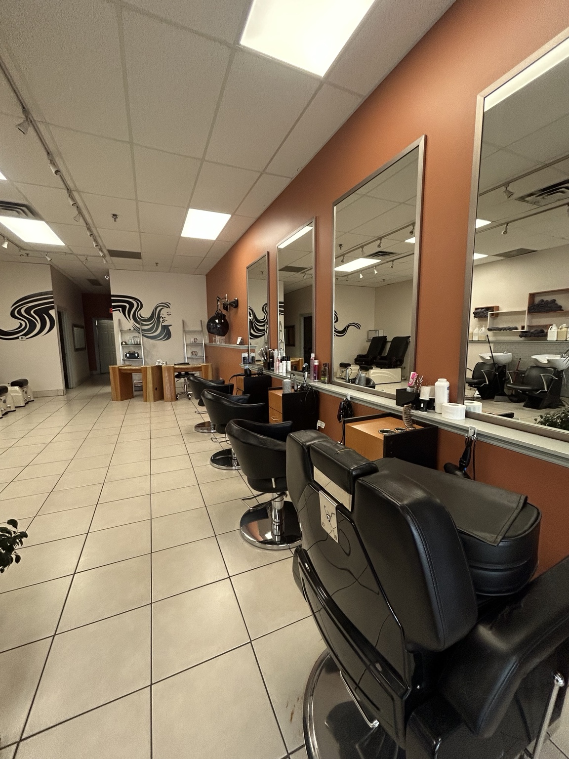 Barber tools — clippers, combs, and scissors arranged on a dark surface