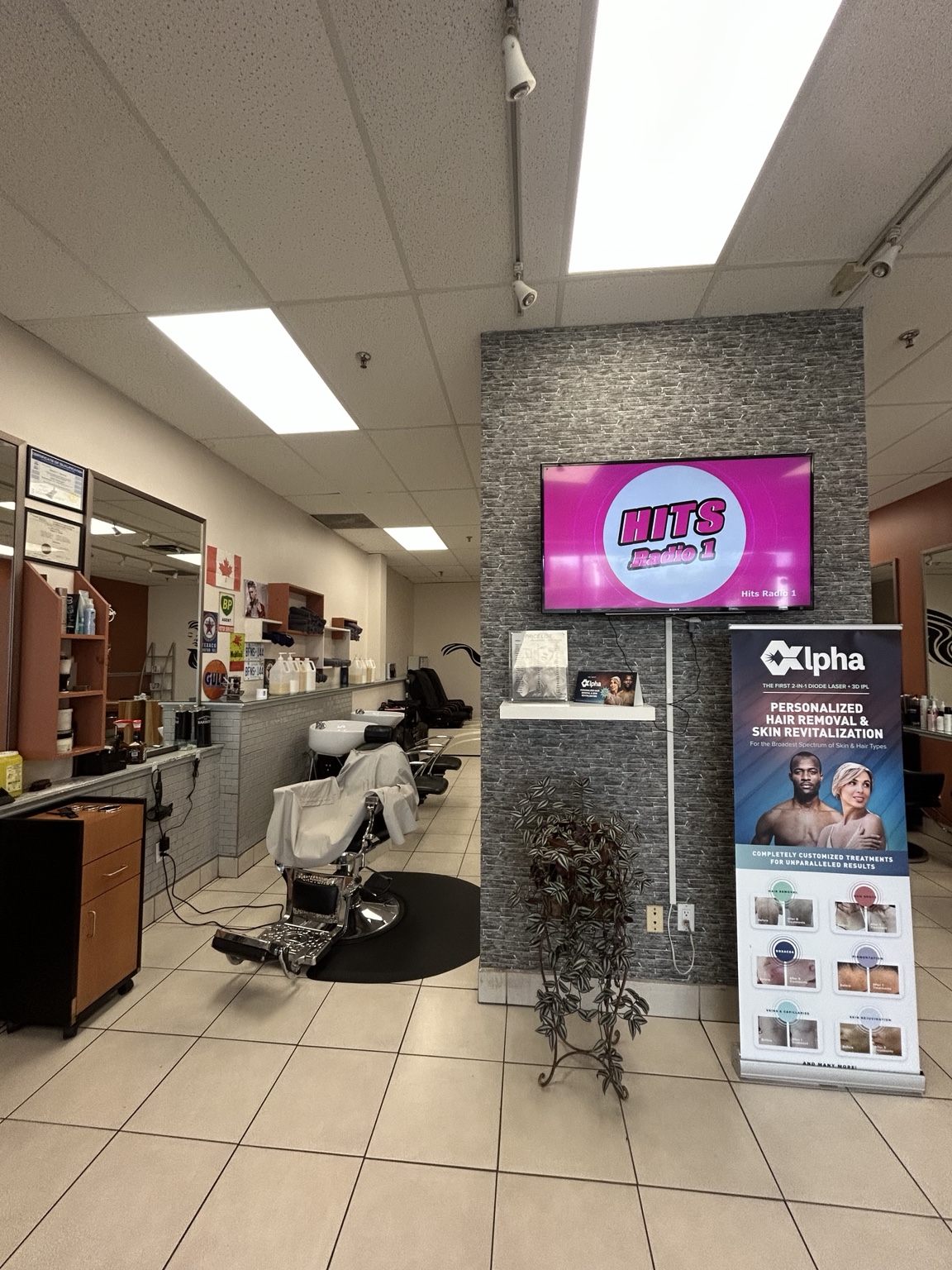 Row of salon chairs under warm overhead lights with mirrors reflecting the space